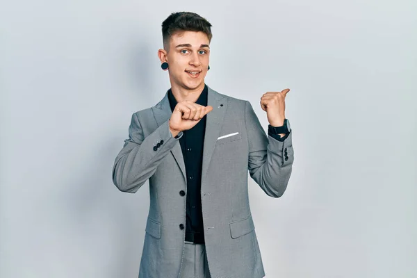 Young Caucasian Boy Ears Dilation Wearing Business Jacket Pointing Back — Foto Stock