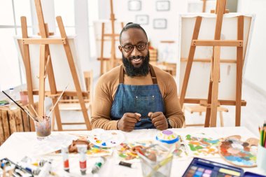 African american artist man at art studio with a happy and cool smile on face. lucky person. 