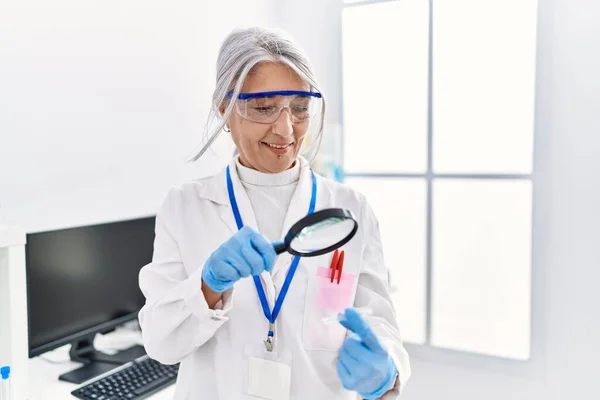 Middle Age Grey Haired Woman Wearing Scientist Uniform Using Magnifying — стоковое фото