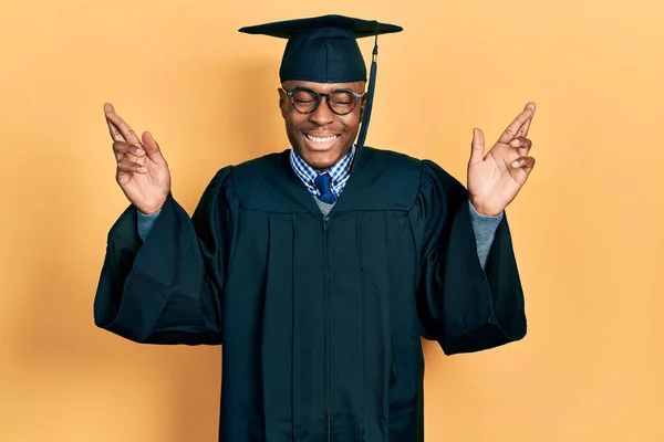 Mladý Afroameričan Promoční Čepici Slavnostním Županu Zkříženým Prstem Usmíval Nadějí — Stock fotografie