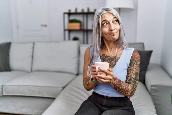 Middle Age Grey Haired Woman Drinking Coffee Sitting Sofa Home — стоковое фото