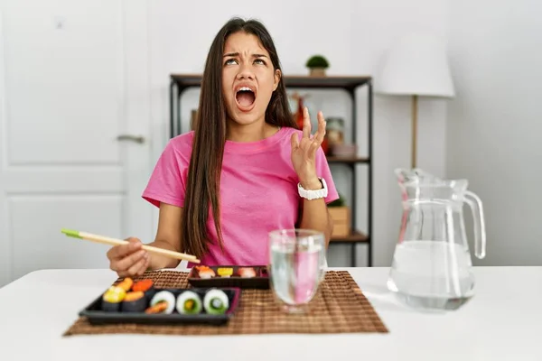 Young Brunette Woman Eating Sushi Using Chopsticks Crazy Mad Shouting — ストック写真