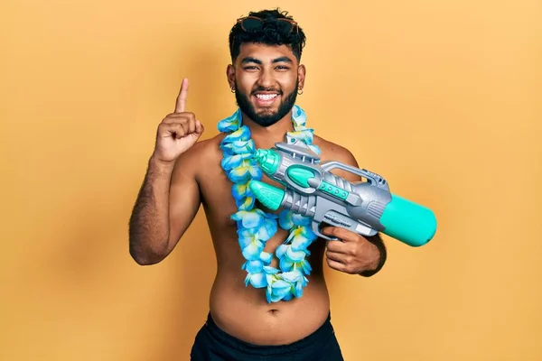 Arabský Muž Plnovousem Plavkách Havajským Lei Vodní Pistolí Usmívající Nápadem — Stock fotografie