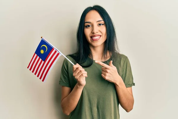 Молодая Латиноамериканка Флагом Малайзии Улыбается Счастливо Указывая Рукой Пальцем — стоковое фото