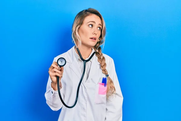 Beautiful Young Blonde Doctor Woman Holding Stethoscope Looking Sleepy Tired — Stock Photo, Image