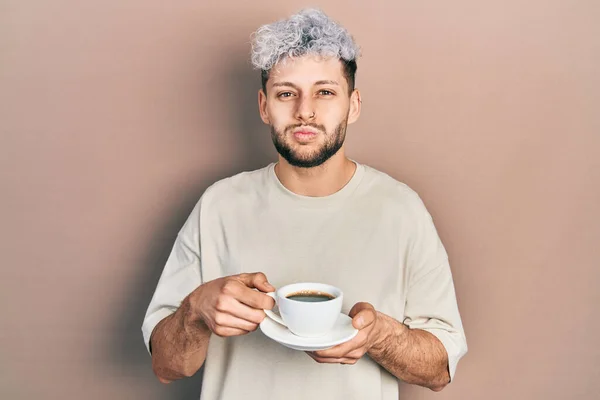 Young Hispanic Man Modern Dyed Hair Drinking Cup Coffee Puffing — Zdjęcie stockowe