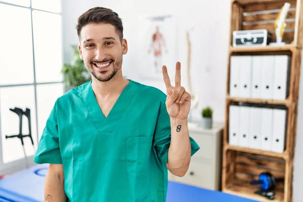 Young Physiotherapist Man Working Pain Recovery Clinic Smiling Happy Face — Fotografia de Stock