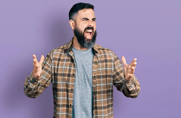 Sakallı, sıradan tişörtlü, deli deli gibi bağıran saldırgan ifadeli ve kollarını kaldırmış İspanyol bir adam. hüsran kavramı. 