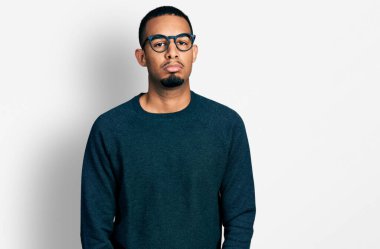 Genç, Afro-Amerikalı bir adam günlük kıyafetler ve gözlük takıyor. Depresyonda ve endişe içinde. Kızgın ve korkmuş. hüzünlü ifade. 