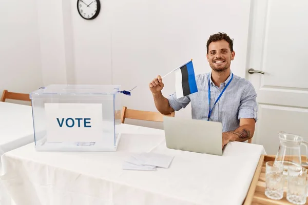 Ung Latinamerikansk Man Ler Säker Innehav Estonia Flagga Arbetar Val — Stockfoto