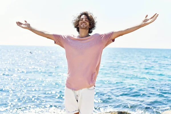 Ung Latinamerikansk Man Andas Stående Med Armarna Öppna Stranden — Stockfoto