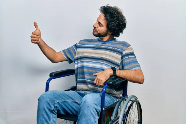 Handsome Hispanic Man Sitting Wheelchair Looking Proud Smiling Doing Thumbs — Foto Stock