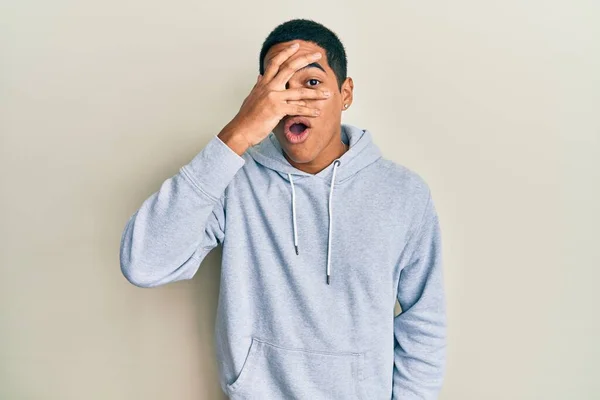 Young Handsome Hispanic Man Wearing Casual Sweatshirt Peeking Shock Covering — Foto de Stock