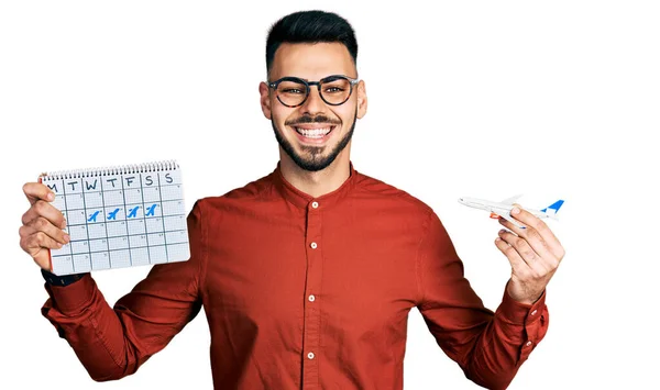 Young Hispanic Man Beard Holding Plane Toy Travel Calendar Smiling — Stock Photo, Image