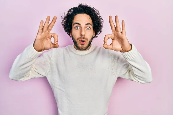 Handsome Hispanic Man Wearing Casual White Sweater Looking Surprised Shocked — Stock fotografie