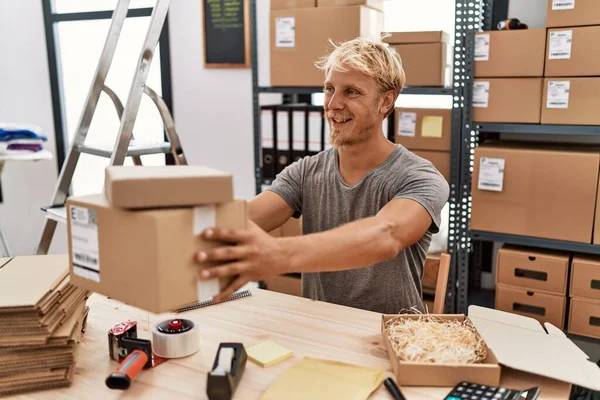 Young Caucasian Man Smiling Confident Holding Package Warehouse — Stok fotoğraf