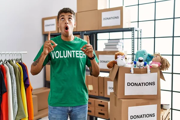 Young Handsome Hispanic Man Wearing Volunteer Shirt Donations Stand Amazed — Stockfoto
