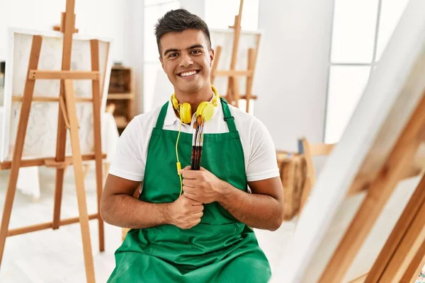 Jonge Spaanse Man Glimlachend Vol Zelfvertrouwen Verfkwasten Vasthouden Kunststudio — Stockfoto