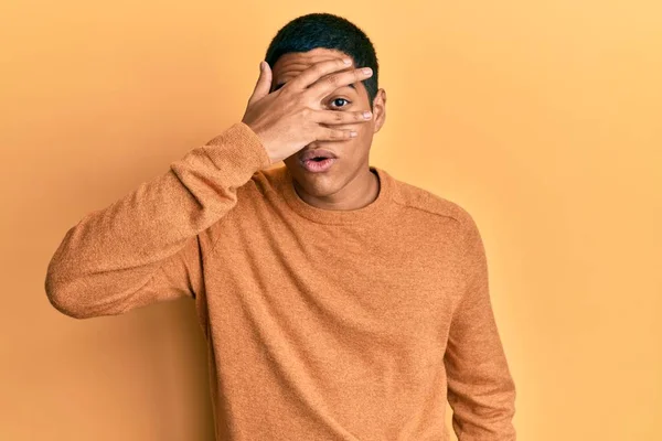 Young Handsome Hispanic Man Wearing Casual Winter Sweater Peeking Shock — Fotografia de Stock