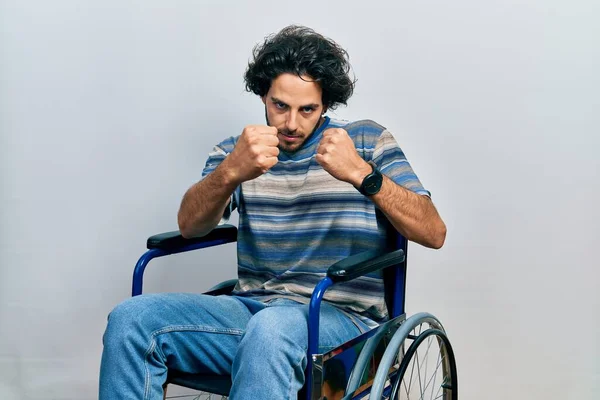 Handsome Hispanic Man Sitting Wheelchair Ready Fight Fist Defense Gesture — Foto Stock