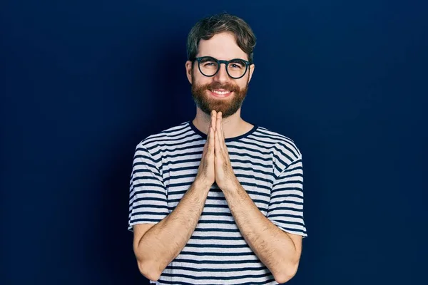Caucasian Man Beard Wearing Striped Shirt Glasses Praying Hands Together — Stockfoto