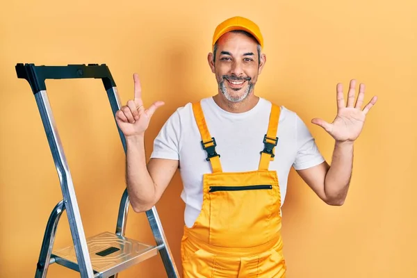 Handsome Middle Age Man Grey Hair Holding Ladder Showing Pointing — Stockfoto