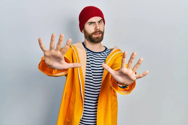 Caucasian Man Beard Wearing Yellow Raincoat Doing Stop Gesture Hands — Stockfoto