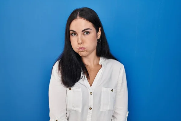 Young Hispanic Woman Standing Blue Background Puffing Cheeks Funny Face — Photo