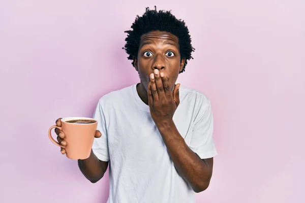 Young African American Man Holding Cup Coffee Covering Mouth Hand — Foto de Stock
