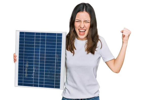 Young Beautiful Girl Holding Photovoltaic Solar Panel Screaming Proud Celebrating — Stock Photo, Image