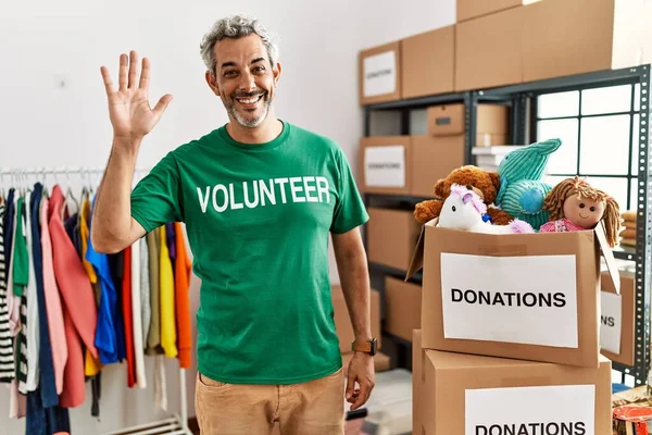 Middle Age Hispanic Man Wearing Volunteer Shirt Donations Stand Waiving — Fotografia de Stock