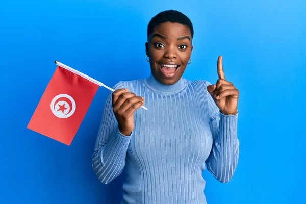 Young African American Woman Holding Tunisia Flag Smiling Idea Question — Stock Fotó