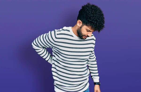 Young Arab Man Beard Wearing Casual Striped Sweater Suffering Backache — Stock fotografie