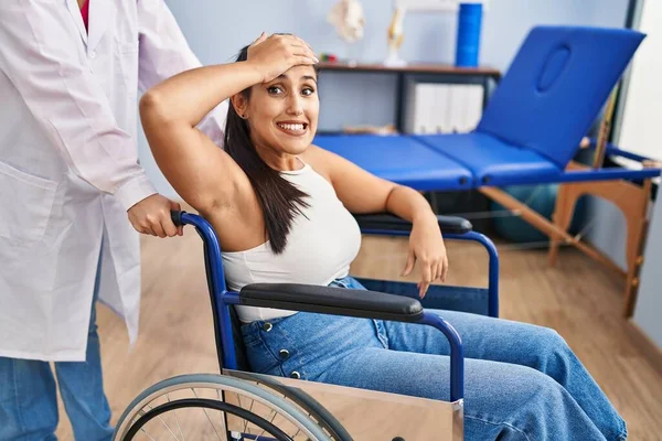 Young Hispanic Woman Sitting Wheelchair Physiotherapy Clinic Stressed Frustrated Hand — ストック写真