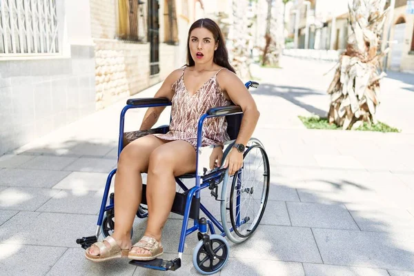 Young Brunette Woman Sitting Wheelchair Outdoors Scared Amazed Open Mouth — Stock fotografie