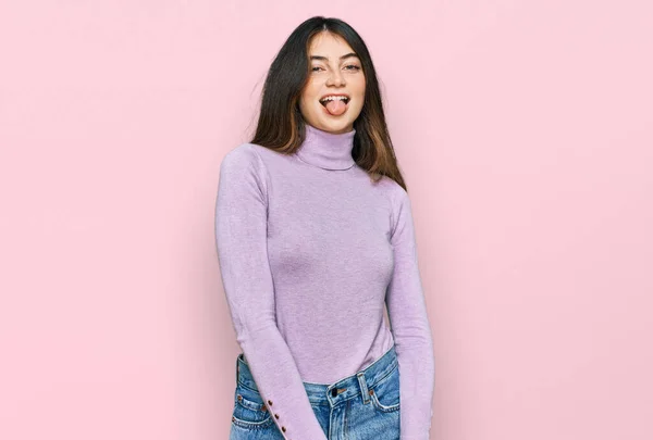 Young Beautiful Teen Girl Wearing Turtleneck Sweater Sticking Tongue Out — Stockfoto