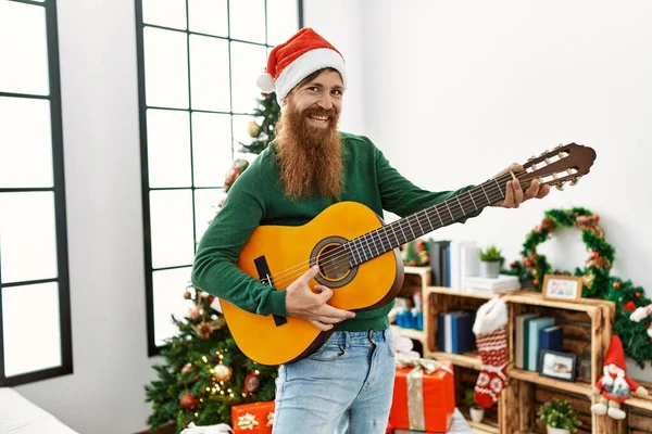 Young Redhead Man Playing Classical Guitar Standing Christmas Tree Home — Fotografia de Stock