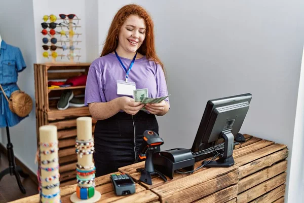 Young Redhead Woman Counting Dollars Banknotes Working Clothing Store — стоковое фото