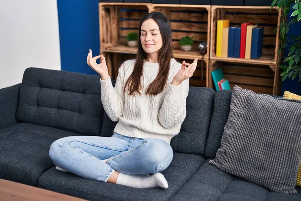 Young Woman Meditating Doing Yoga Exercise Sitting Sofa Home — Stock fotografie