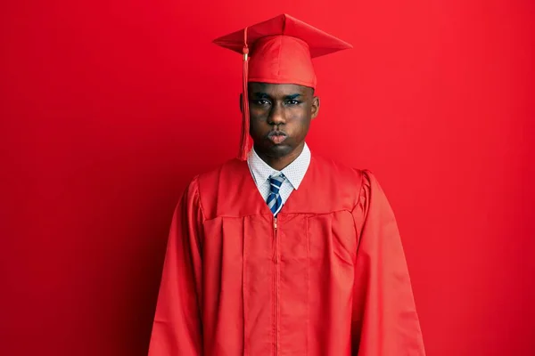 Young African American Man Wearing Graduation Cap Ceremony Robe Puffing — Stock Photo, Image