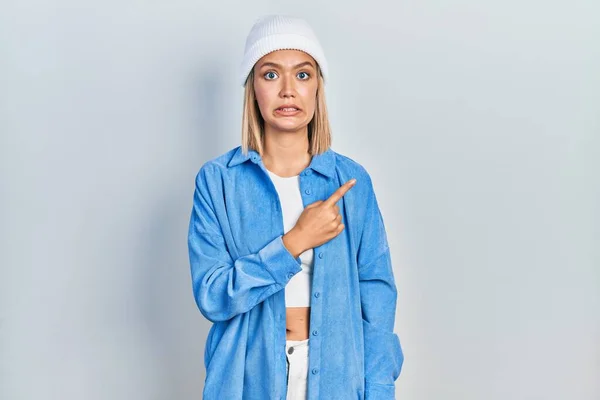 Beautiful Blonde Woman Wearing Wool Hat Pointing Aside Worried Nervous — Stok fotoğraf