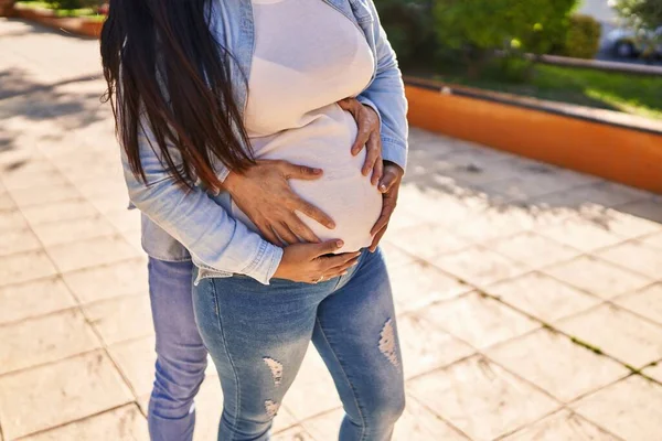 Young Latin Couple Expecting Baby Touching Belly Hugging Each Other — Stock Fotó