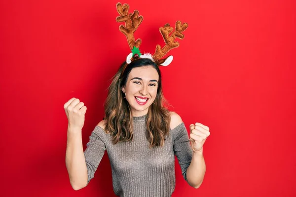 Young Hispanic Girl Wearing Deer Christmas Hat Screaming Proud Celebrating — Stock fotografie