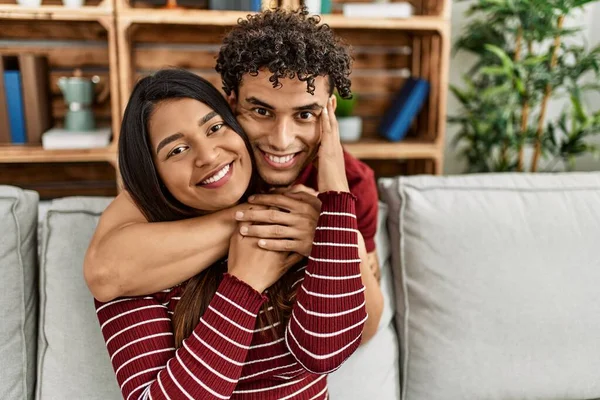 Young Latin Couple Smiling Happy Hugging Sitting Sofa Home — Stock Photo, Image
