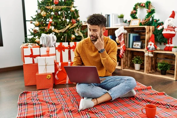 Arab Young Man Using Laptop Sitting Christmas Tree Pointing Eye — Foto de Stock