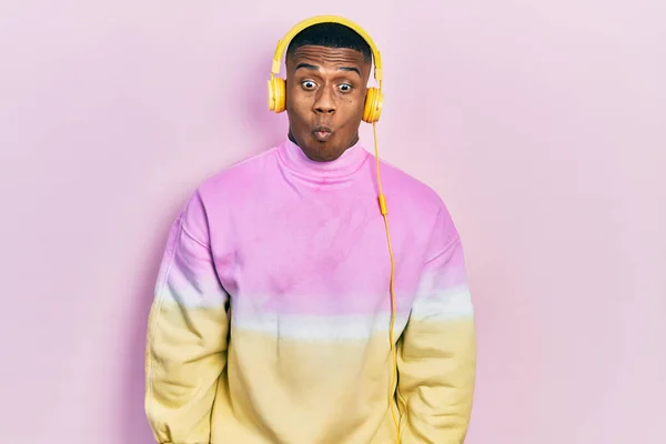 Young Black Man Listening Music Wearing Headphones Making Fish Face — Fotografia de Stock