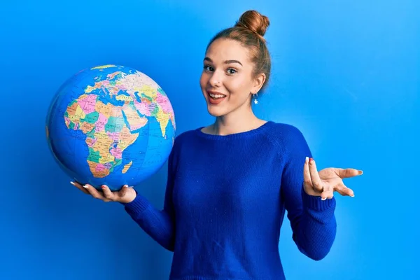 Young Blonde Woman Holding World Ball Celebrating Achievement Happy Smile — Stock Photo, Image