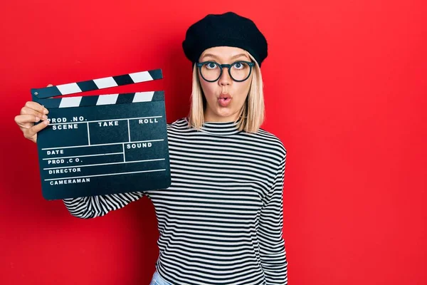 Krásná Blondýnka Drží Video Film Clapboard Vyděšený Ohromený Otevřenými Ústy — Stock fotografie