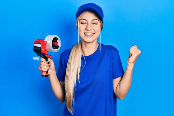 Young Beautiful Caucasian Woman Holding Packing Tape Screaming Proud Celebrating — Stockfoto