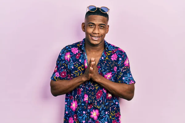 Young Black Man Wearing Hawaiian Shirt Sunglasses Praying Hands Together — Stock Fotó